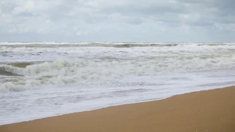 Storm waves on a sandy beach under a bright sky Stock Footage 82120853