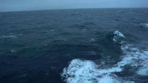 Storm. Waves from ship along side. White foam on wind. Side view low on water Stock Footage 260269164