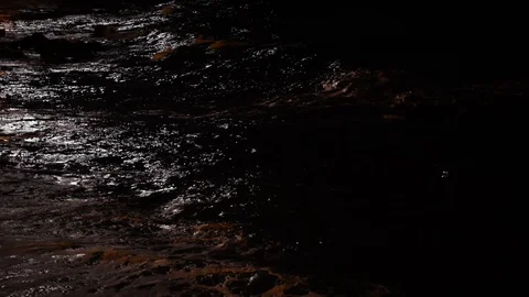 Storm waves splashes in the night. Night view on the sea. Moonlight reflecting Stockbeeldmateriaal 121970212