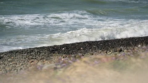 Storm winds making waves on the mediterranean Sea, close up stone beach Stock Footage 153797291