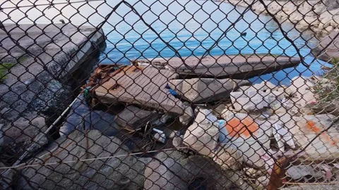 Storm-Wrecked Harbor, Pollution Behind Rusty Fence Stock Footage 303399662