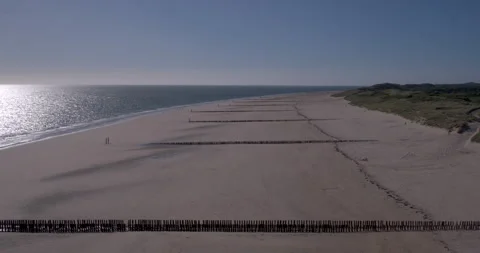 Stormbreakers on the beach in The Netherlands shot with drone Stock Footage 197563152