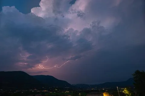 Stormcloud with lightning over the mountains Stock Photos