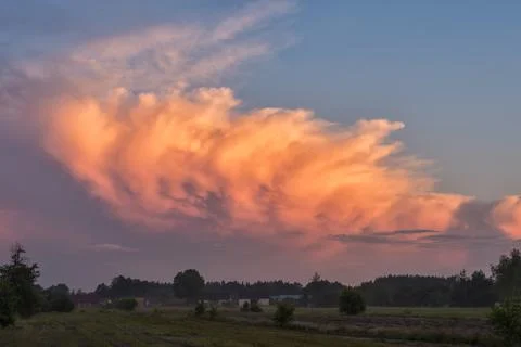 Stormcloud with sunset light on the twilight sky Stock Photos