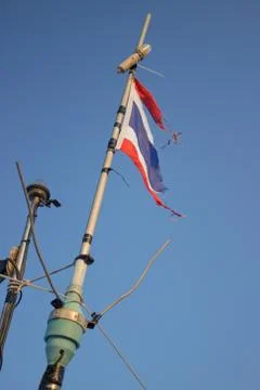Storms battered the Thai flag on the mast Stock Photos