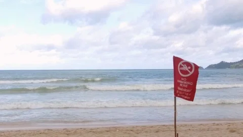 Storms season. Red warning flag on the beach - no swimming Video stock 76506534