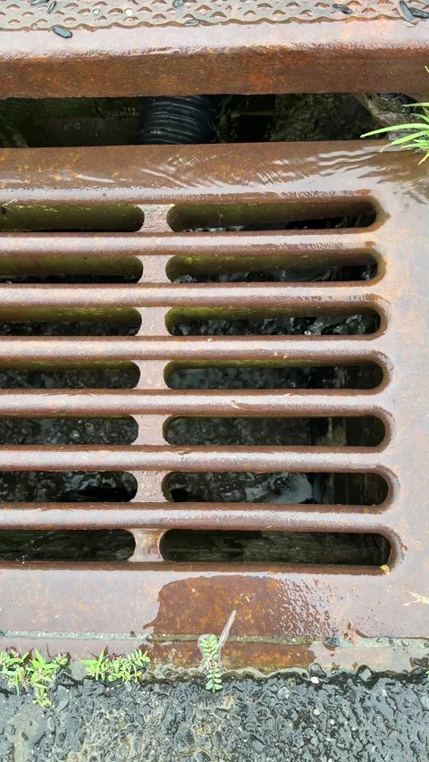 Stormwater Flowing Into Rusty Storm Drain Stock-Footage 339080627