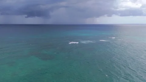 Stormy clouds on the background over crystal clear Caribbean Sea water Stock Footage 325499984