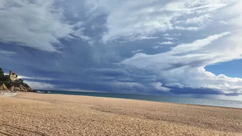 Stormy clouds moving fast above empty beach in Lloret de Mar, Spain, timelapse Stock Footage 266087437