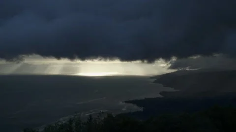 Stormy clouds moving in over a lakeside mountain Stock Footage 41499989