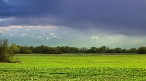 Stormy clouds over green meadow. Video stock 62840673