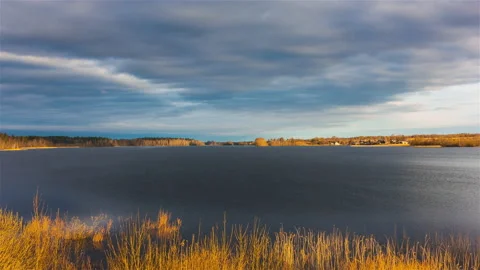 Stormy clouds over lake surrounded by yellow autumn forest Stock Footage 170438867