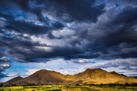 Stormy clouds over mountains Stock Photos