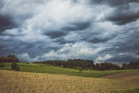 Stormy cloudscape over fields and pasture Stock Photos