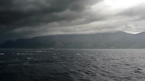 Stormy dark adriatic sea on Croatian shoreline with dense clouds Stock Footage