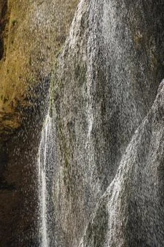 A stormy falling waterfall with splashes in the mountains Stock Photos