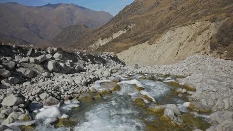 A stormy mountain river flows against the background of mountains Stock-Footage 241924305