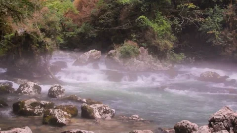 A stormy mountain river flows among the stones. Fog over water Stock Footage 148291829