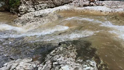 A stormy mountain river flows through the rocks Stock Footage 158697379