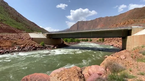 A stormy mountain river flows under the bridge Video stock 241076663