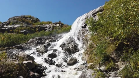 A stormy mountain stream flowing over rocks Video stock 144859777