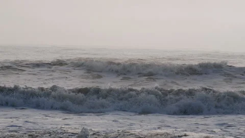 Stormy ocean with rolling big bubble waves on hazy sunny summer day 스톡 동영상 306889803