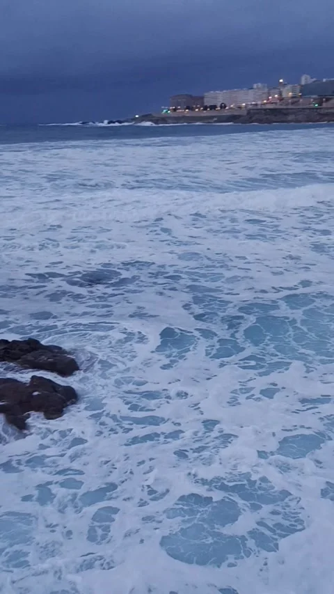 Stormy ocean surf in the evening city bay Stock Footage 236644501