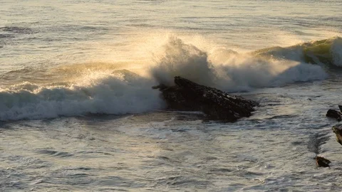 Stormy ocean waves, and cliffs at high tide at sunset Stock Footage 123170934