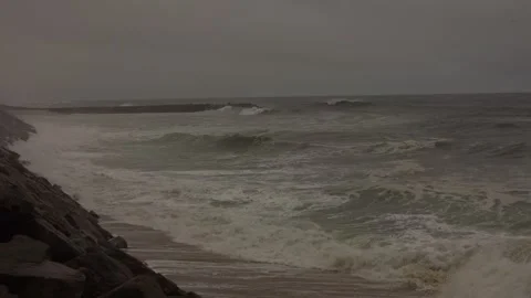 Stormy Ocean Waves Crash at Sunset: Powerful Surf on a Cloudy Beach Stock Footage 288685939