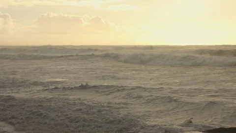 Stormy Ocean Waves Crash at Sunset: Powerful Surf on a Cloudy Beach Video stock 288686164