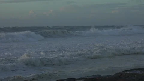 Stormy Ocean Waves Crash at Sunset: Powerful Surf on a Cloudy Beach Video stock 288686838