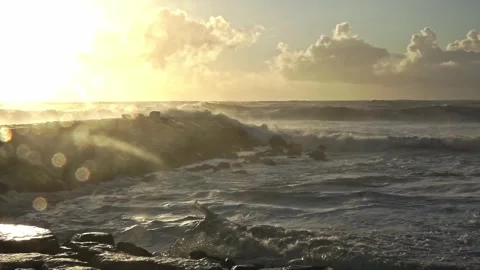 Stormy Ocean Waves Crash at Sunset: Powerful Surf on a Cloudy Beach Video stock 288687475