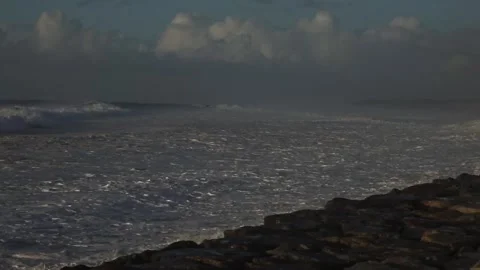 Stormy Ocean Waves Crash at Sunset: Powerful Surf on a Cloudy Beach Video stock 288687492