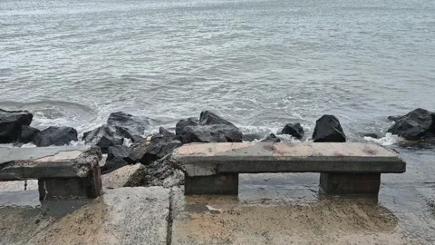 Stormy ocean waves hitting the rocks and sidewalk, flood in a coastal town Stock Footage 302297378