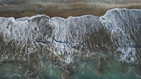 Stormy ocean waves splashing on a pebble coast . Sea windy waves 動画素材 263096429