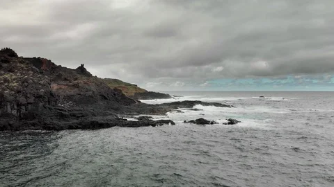 Stormy ocean, white foam from the waves that hit the coastline, reefs of frozen Video stock 104233565