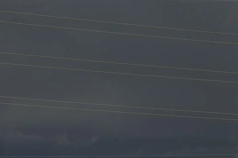 Stormy power lines over brooding horizon, weather monitoring scene Stock Photos