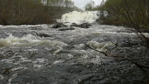 Stormy river flow on the background of a waterfall, slow motion footage. Stock Footage 102748366