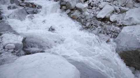 A stormy river of mountain water flows down through large stones 2 Vídeo Stock 103968971