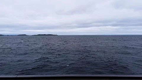 Stormy sea with a distant lighthouse island. Stock Footage 341789927
