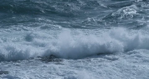 Stormy sea with powerful waves crashing into rocks in slow motion Stock Footage 126687166