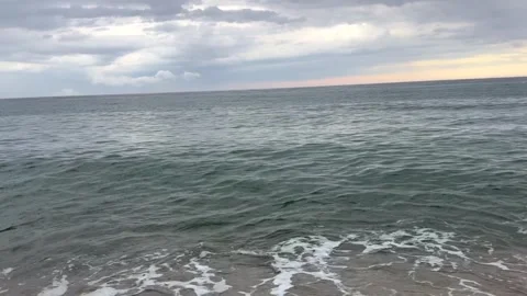 Stormy sea with rolling waves under dramatic gray clouds before rain. Powerful Video stock 337777129