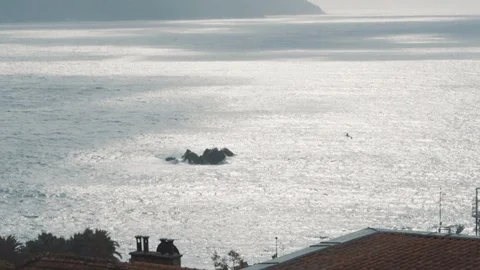 Stormy sea with a view through the roofs of houses Video stock 128686602
