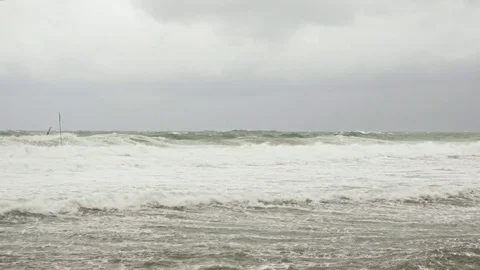 Stormy sea with warning flags under the gray sky Stock Footage 82118931