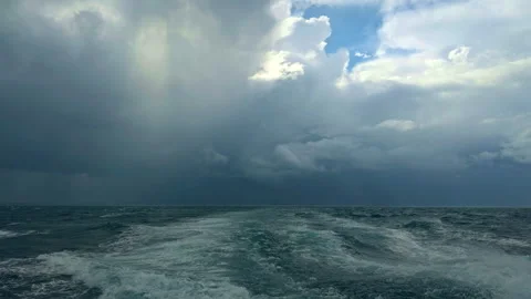 Stormy Sea Waves and Ship Wake Under Dark Clouds Stock Footage 332182816