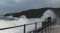 Stormy seas and waves crash onto promenade and drench the cameraman HD Footage