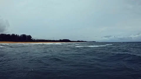 Stormy Seascape with Dark Clouds Over Calm Ocean Waves at Dusk Stock Footage 311320009