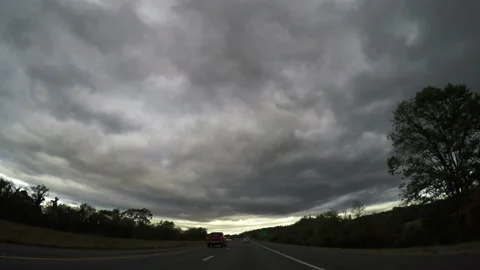 Stormy sky with dense grey clouds over a rural motorway Stock Footage 155760533