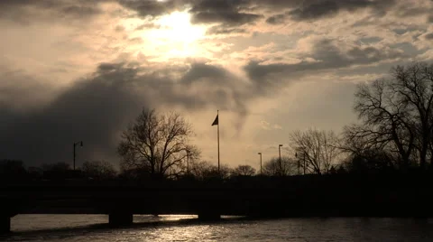 Stormy Sky with Flag and River in Foreground Stock Footage 49018863