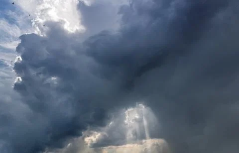 Stormy sky with gray clouds before the rain. Weather forecast concept. Stock Photos